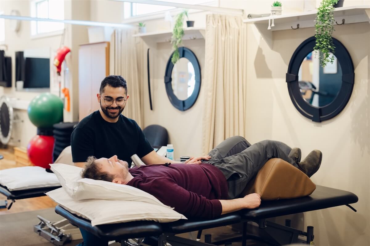 Physiotherapist working with a patient on a treatment table in Osoyoos