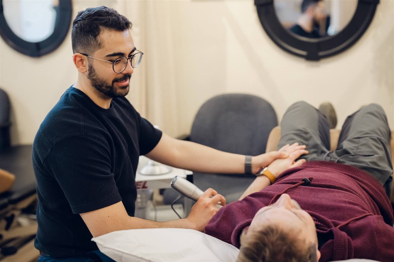 Physiotherapist assessing a patient's leg at our Osoyoos clinic